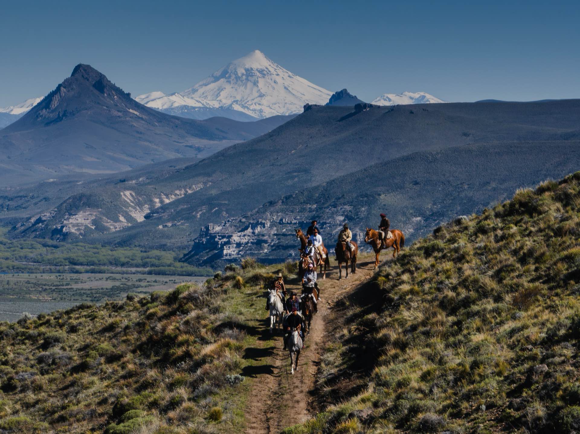 Horseback riding with Volcán Lanín in the distance
