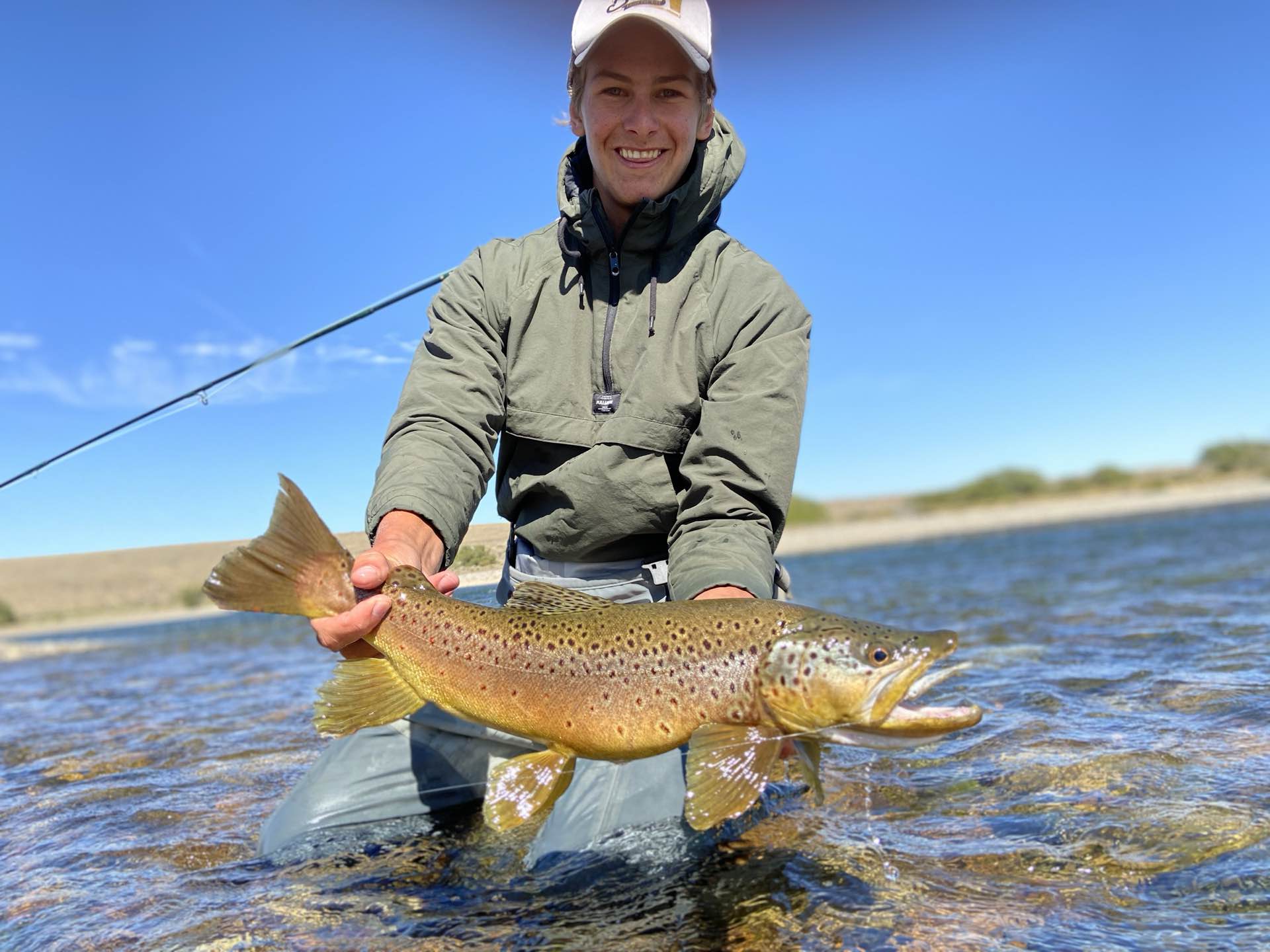 An angler holding a wild brown trout