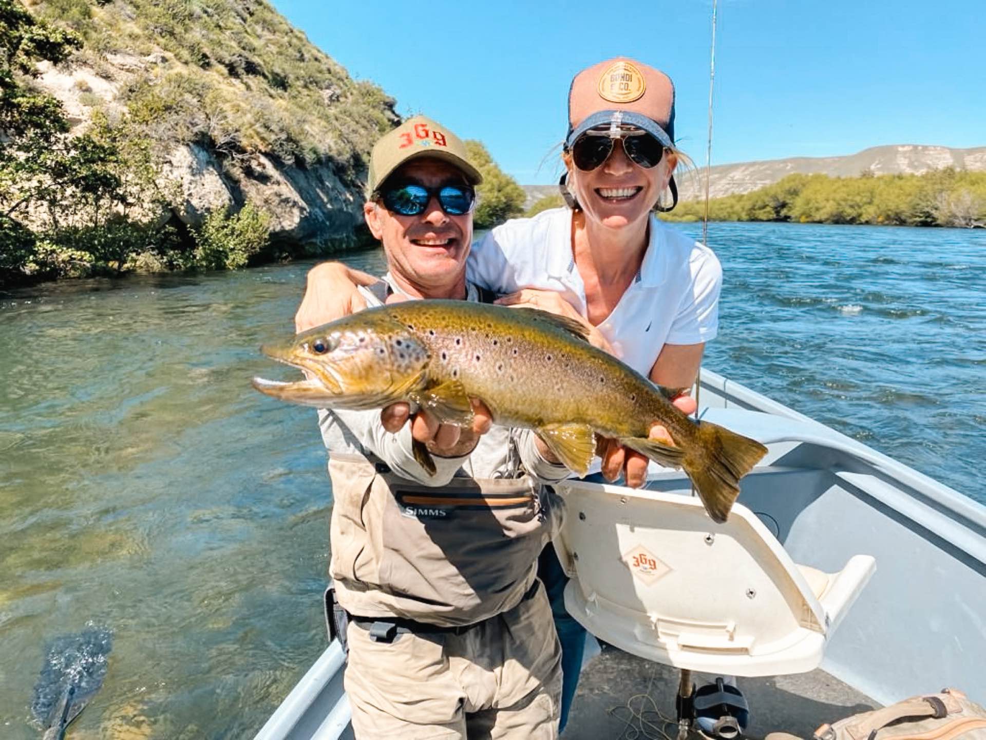 Anglers with a brown trout on a float trip