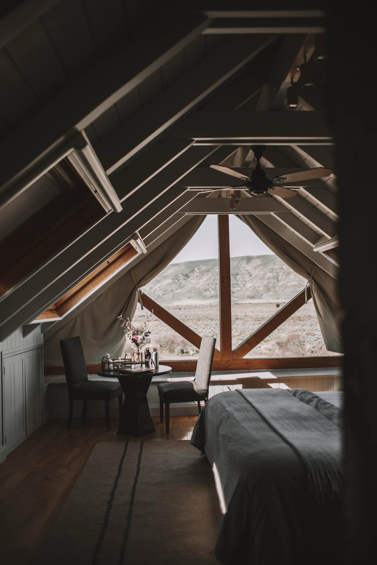 An attic bedroom with a wide window