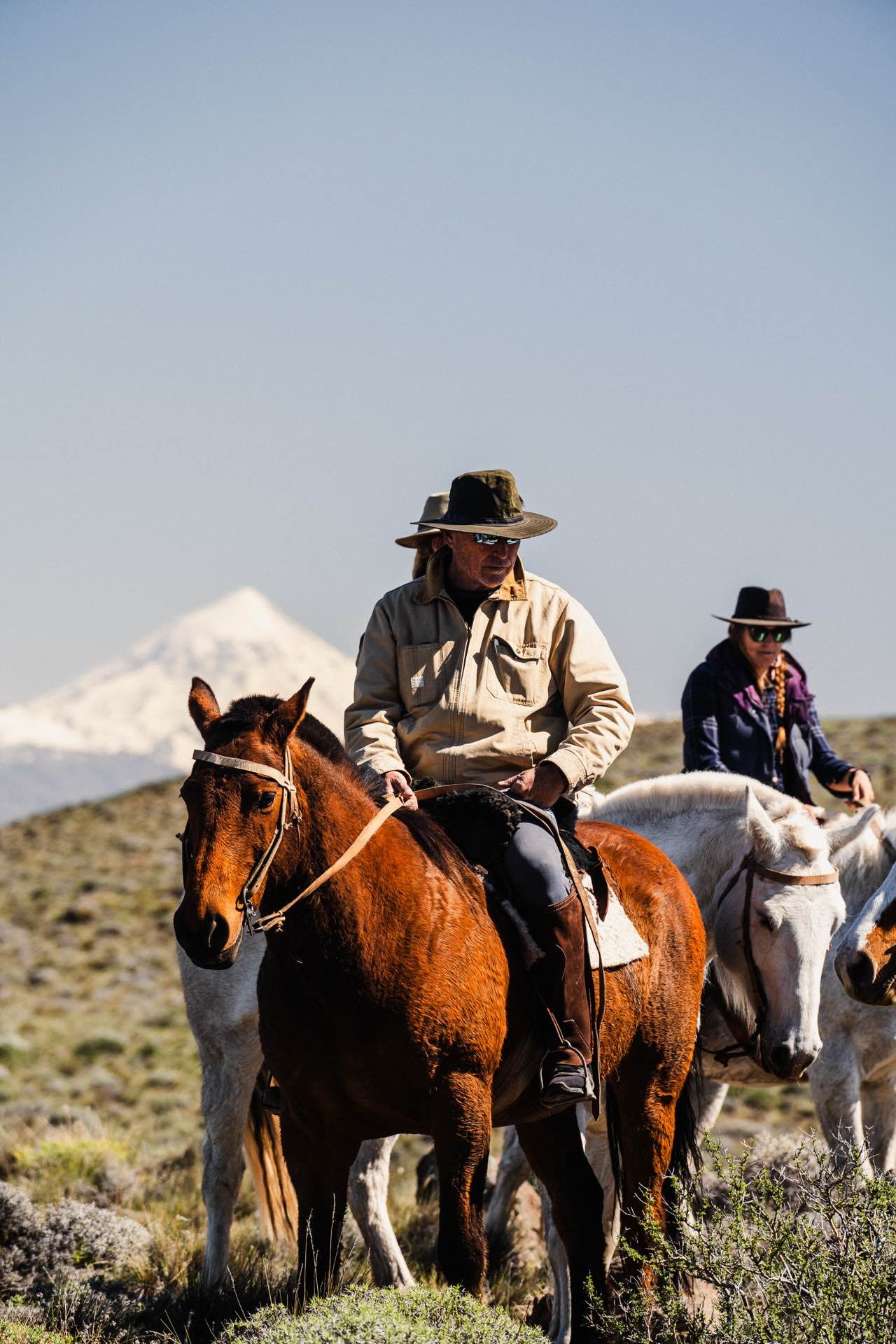 Riders crossing the hills above the valley