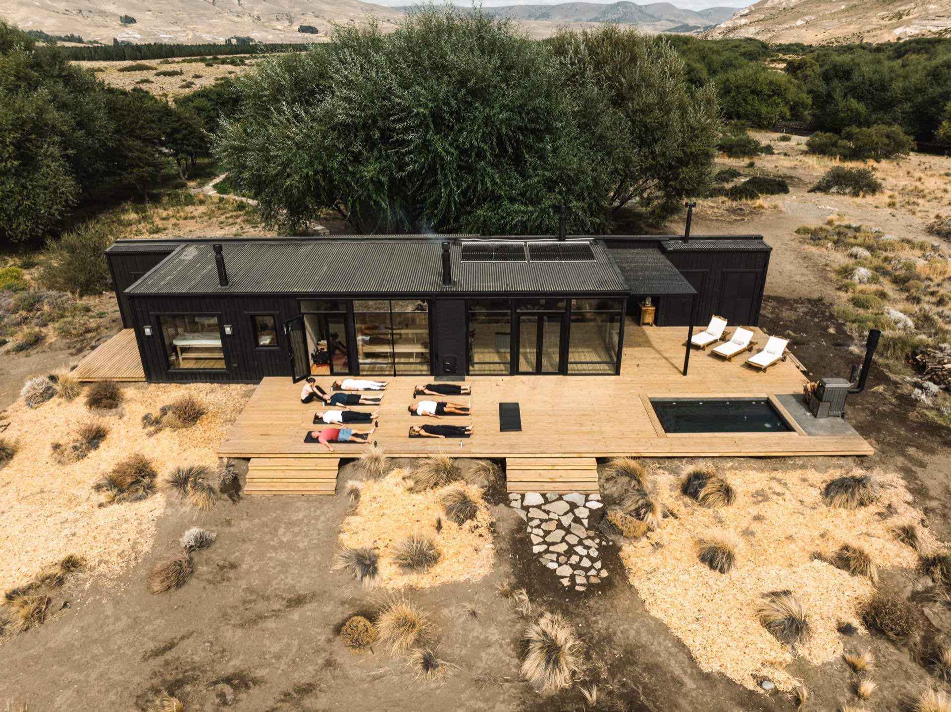 The spa deck with loungers and hot tub