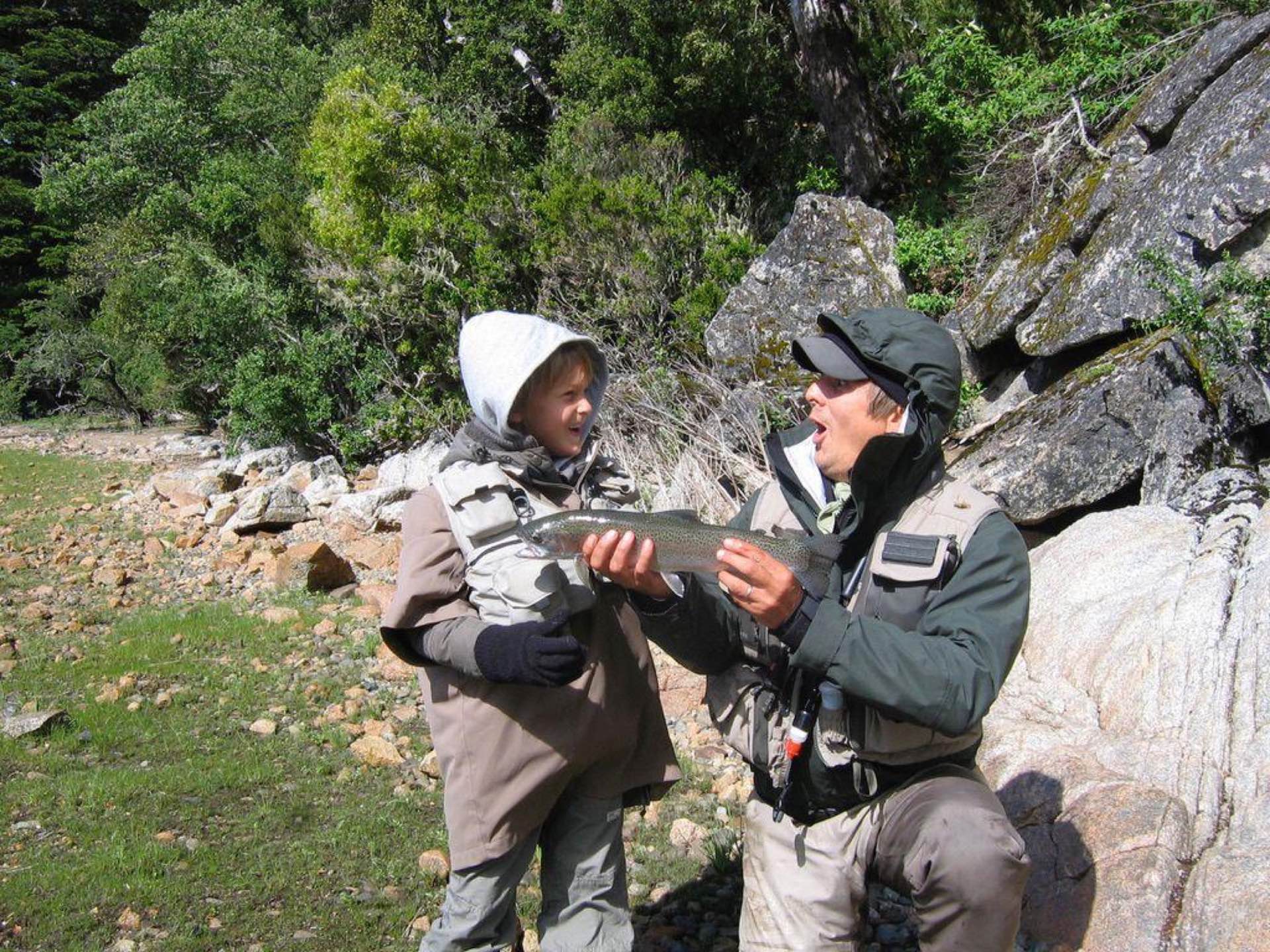 A young angler and a guide with a trout
