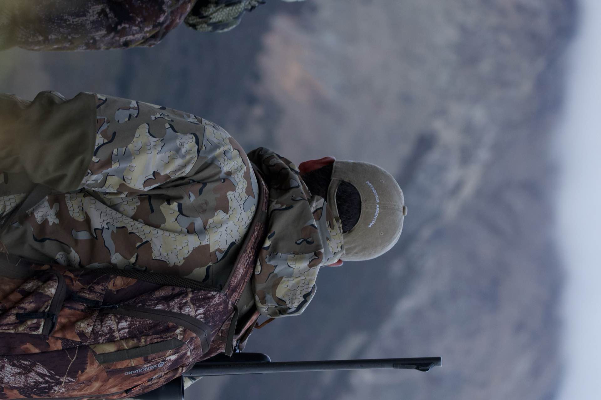A hunter looking out at the mountains